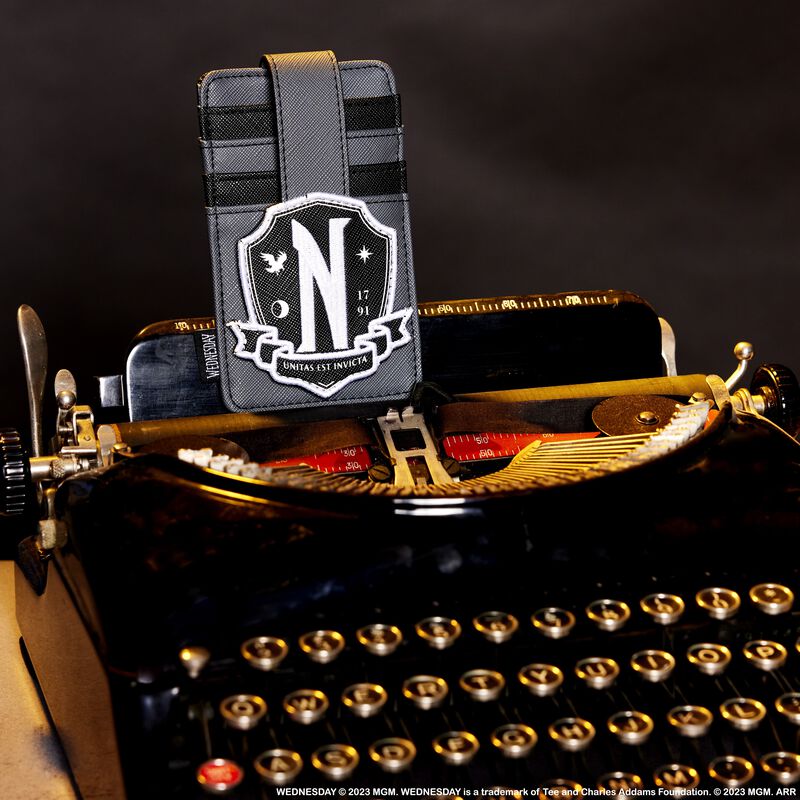 Image of our Wednesday Addams Nevermore Cosplay Card Holder sitting on top of a typewriter